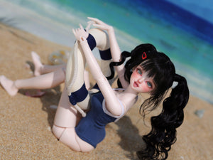 Lucia BJD Head MSD 1/4 doll with black pigtails in a blue swimsuit on a sandy beach
