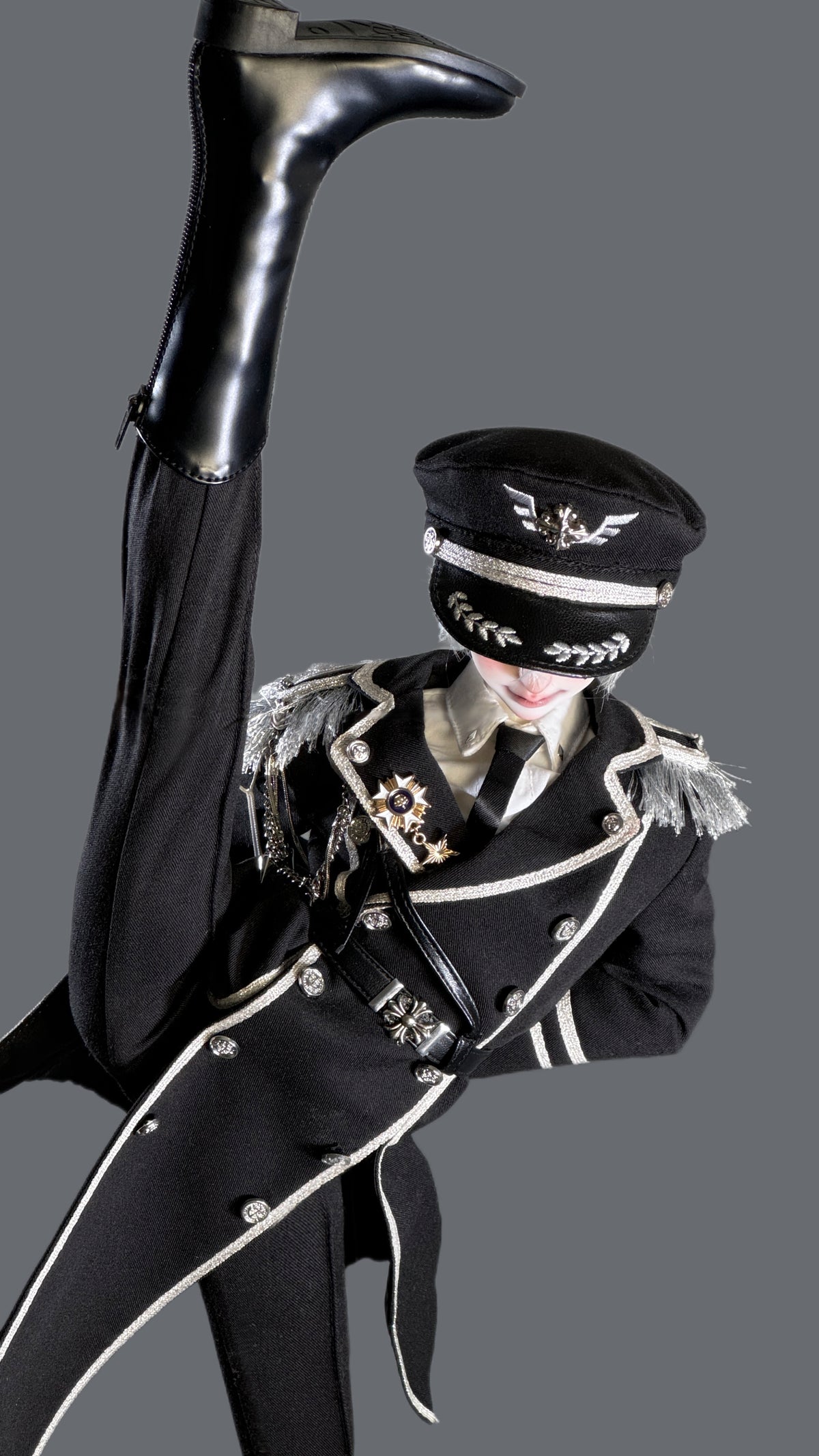 MDollSchool BJD doll in a black military uniform with silver trim and a captain's hat.