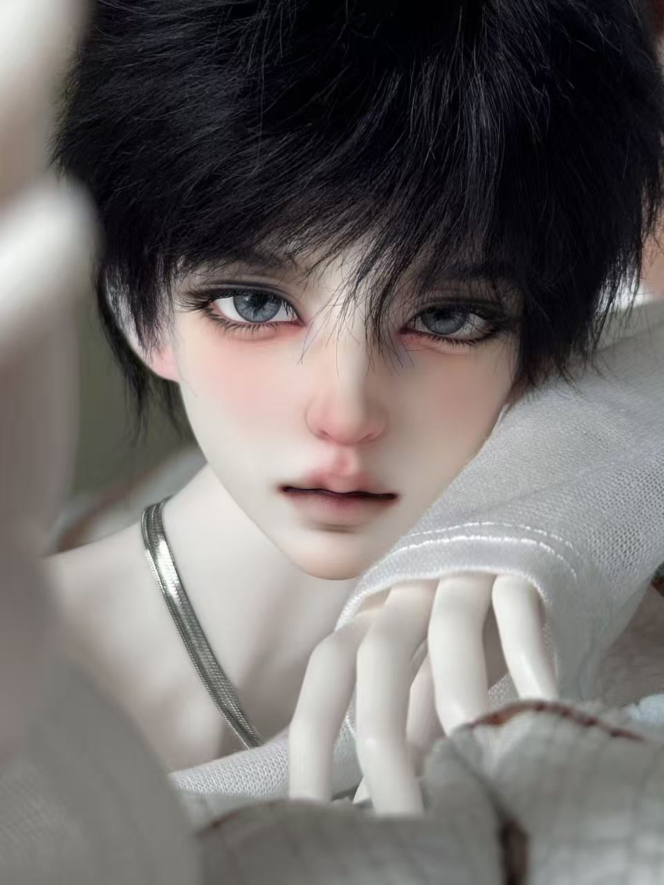 Close-up of Muhan Bao 1/3 scale BJD doll head with black hair and blue eyes.