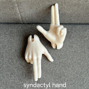 Two cream-colored resin syndactyl hands for MDollSchool 1/4 BJD dolls on a gray surface.