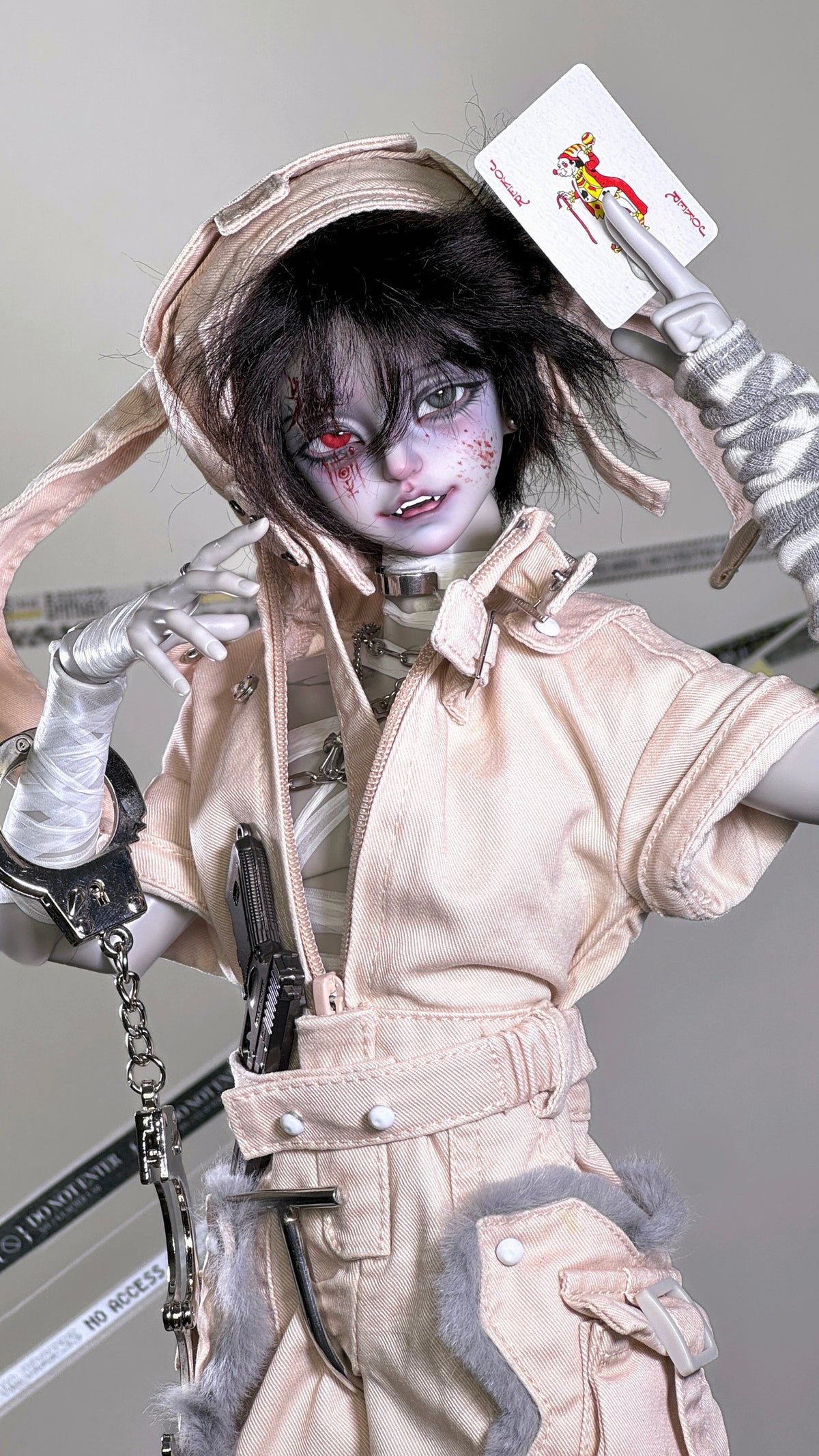 Muhan Abe BJD 1/4 scale doll head with gothic makeup, pink outfit, and handcuffs.