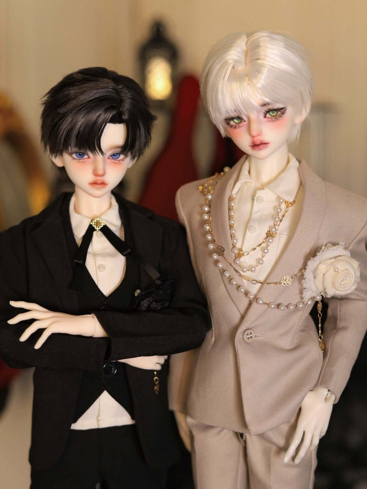 Two MDollSchool Alpha BJD dolls in stylish black and beige suits with pearl accessories.