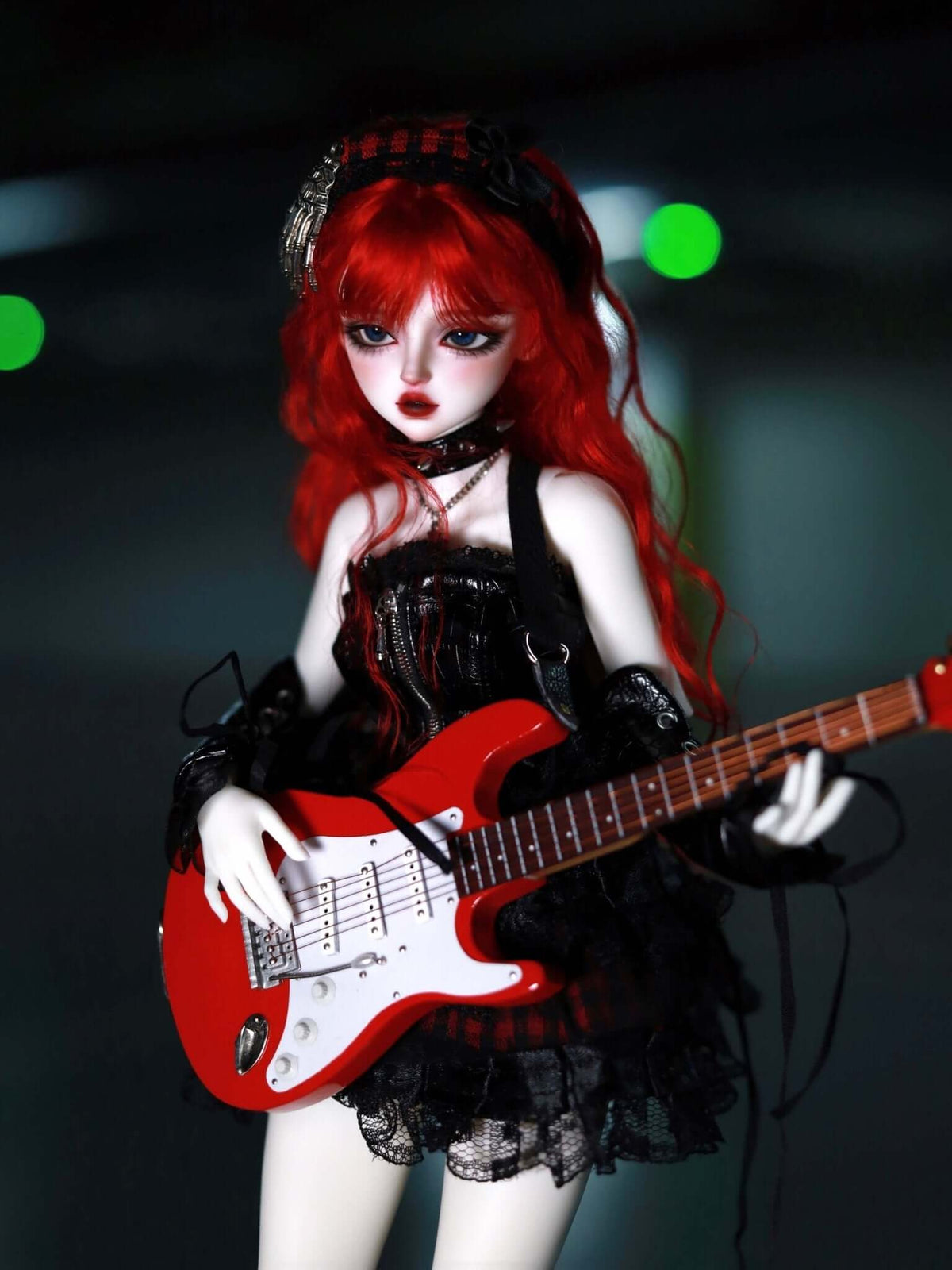 MDollSchool KiKi BJD doll with red hair in a gothic black dress playing a red electric guitar